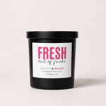 Load image into Gallery viewer, A black jar candle with a white label reading 'FRESH out of fucks' in pink and black text, plus 'SEA SALT &amp; ORCHID'.  shown on a light beige background.
