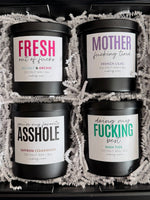 Load image into Gallery viewer, Four black candles with colorful labels in a decorative box.
