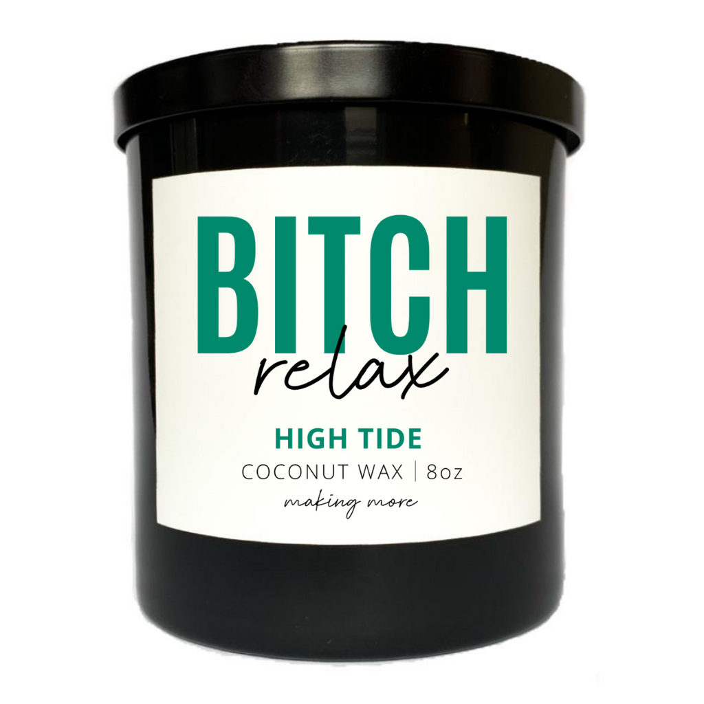 8 oz coconut wax candle in a black glass jar. White label that says bitch relax. The Fragrance is called High Tide.