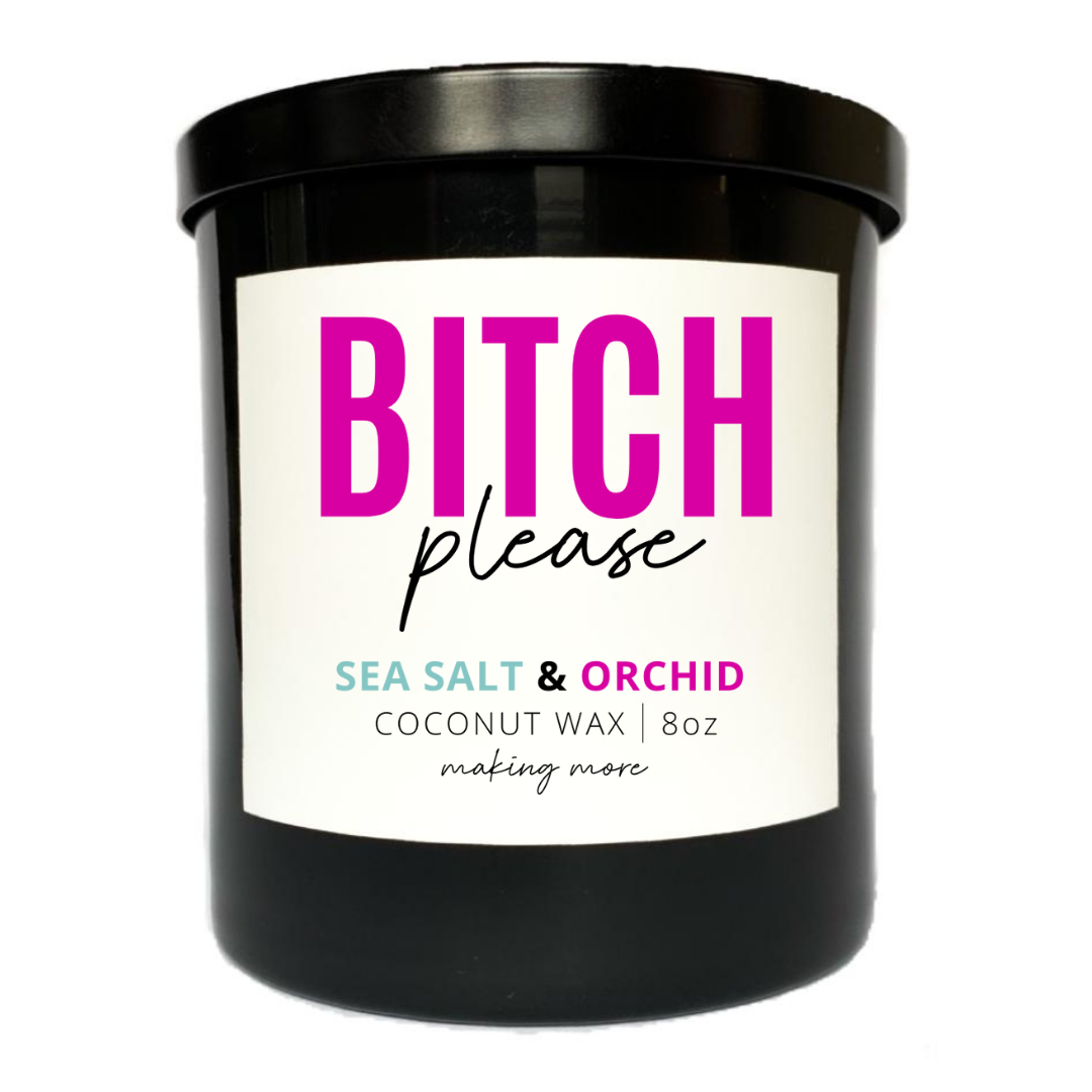 8 ounce coconut wax candle in a black glass jar with a white label that says bitch please. The fragrance is sea salt and orchid.