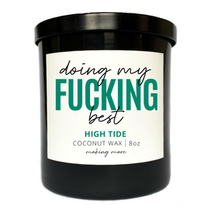 8 ounce coconut wax candle in a black glass jar. White label that says doing my fucking best. Fragrance is high tide.