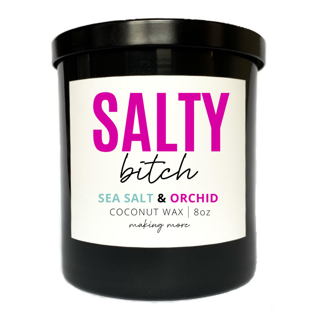8 ounce coconut wax candle in black glass jar. White label that says salty bitch. Fragrance is sea salt and orchid. 
